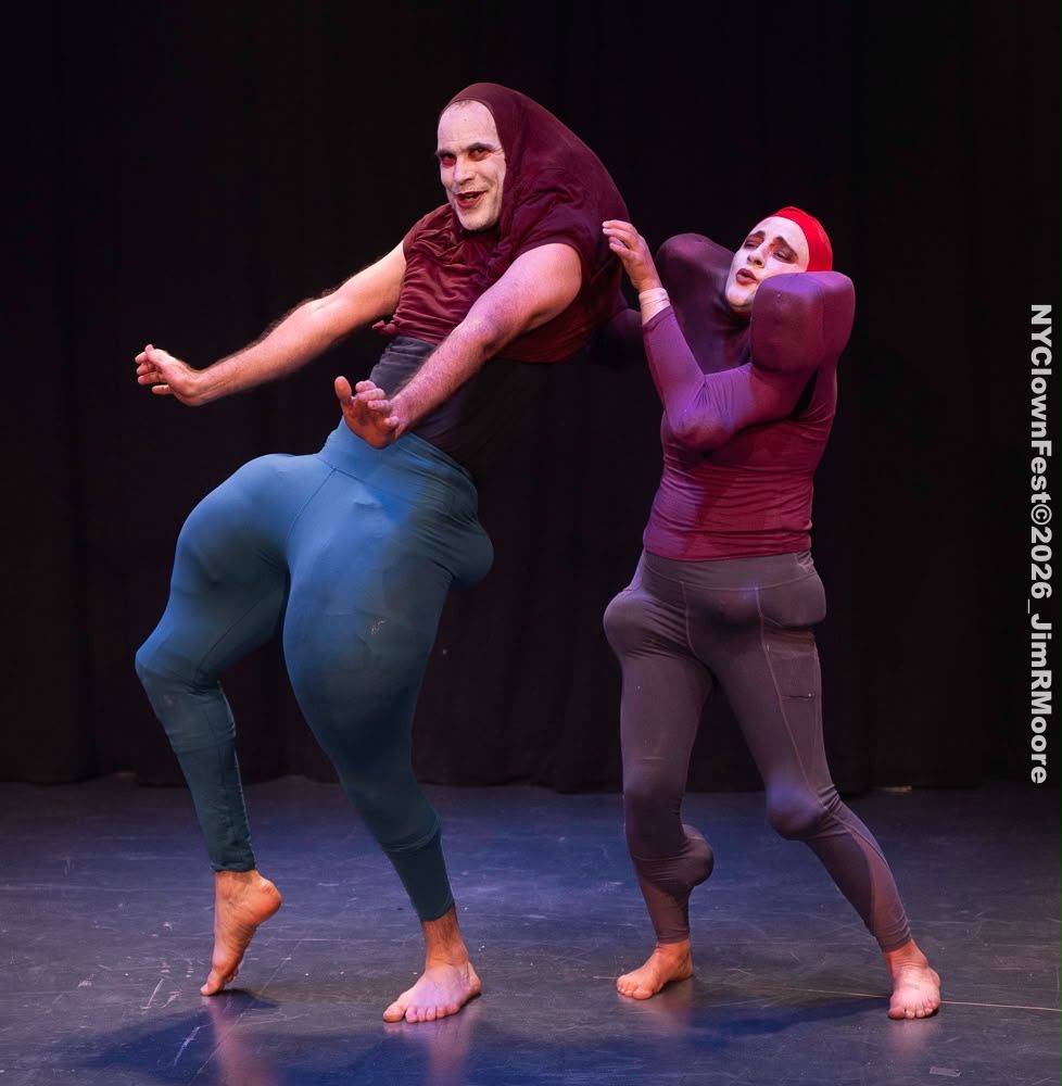 The tall bouffon leans back on one leg while the smaller one pushes against him.